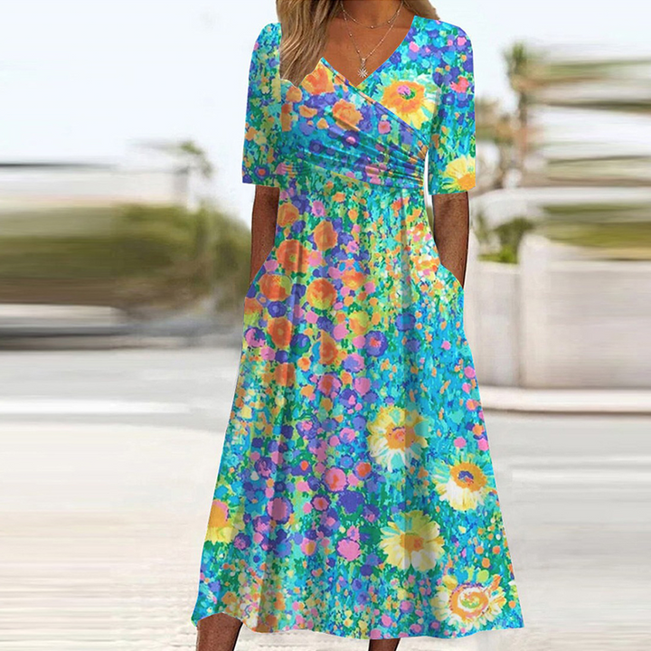 Freesia - Midi-Blumenkleid mit kurzen Ärmeln" could be rewritten as "Freesia - Midi-Kleid mit floralem Muster und kurzen Ärmeln.