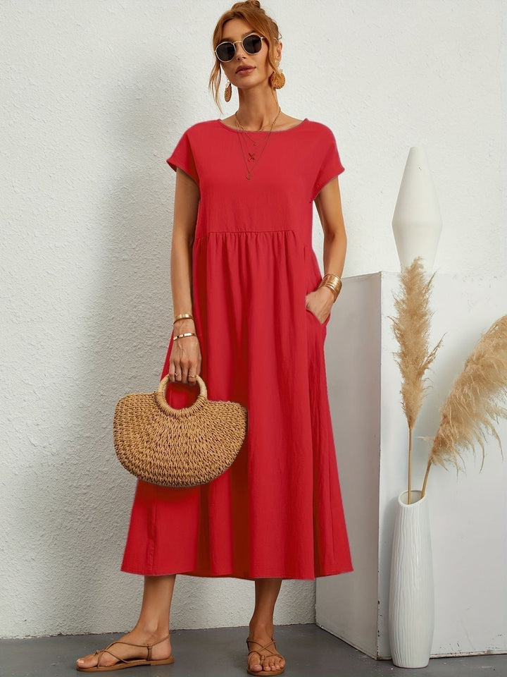 "Kimber - Midi-Relaxed Kleid mit Rundhalsausschnitt" could be rewritten as "Kimber - Midi-Relaxed Kleid mit Rundhalsdesign".
