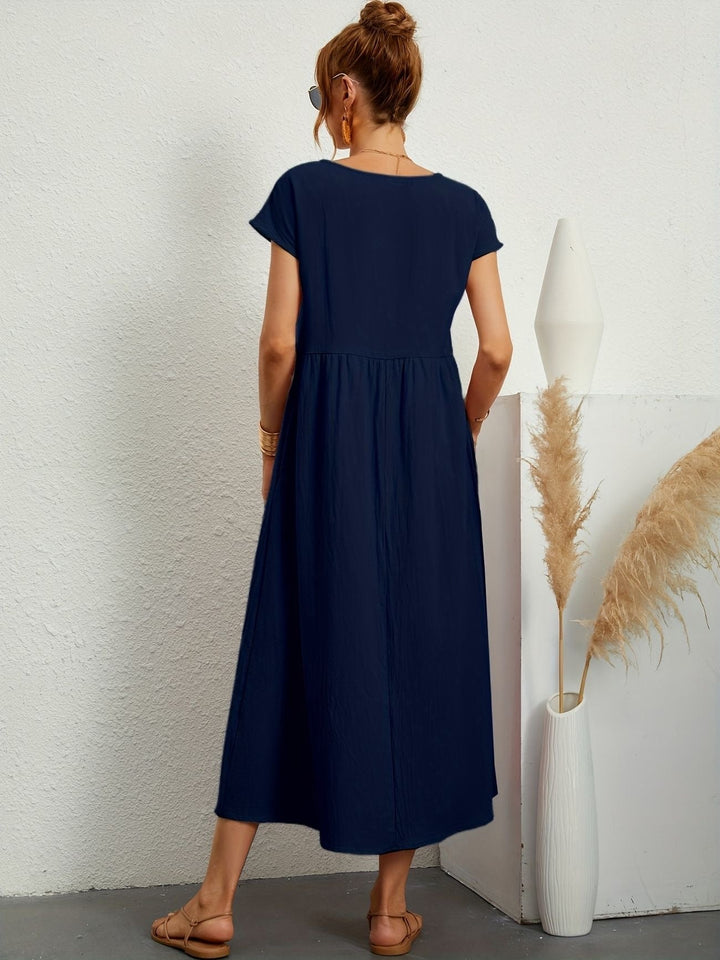 "Kimber - Midi-Relaxed Kleid mit Rundhalsausschnitt" could be rewritten as "Kimber - Midi-Relaxed Kleid mit Rundhalsdesign".