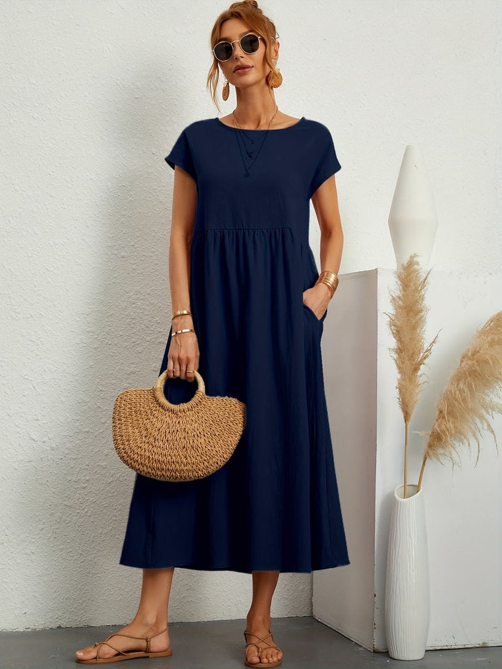 "Kimber - Midi-Relaxed Kleid mit Rundhalsausschnitt" could be rewritten as "Kimber - Midi-Relaxed Kleid mit Rundhalsdesign".