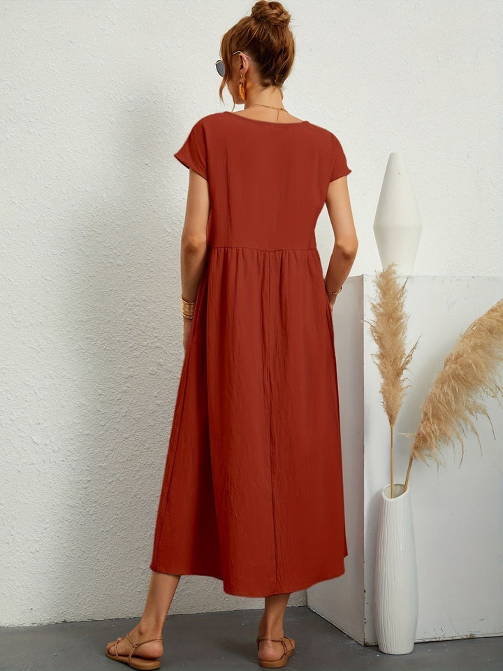 "Kimber - Midi-Relaxed Kleid mit Rundhalsausschnitt" could be rewritten as "Kimber - Midi-Relaxed Kleid mit Rundhalsdesign".