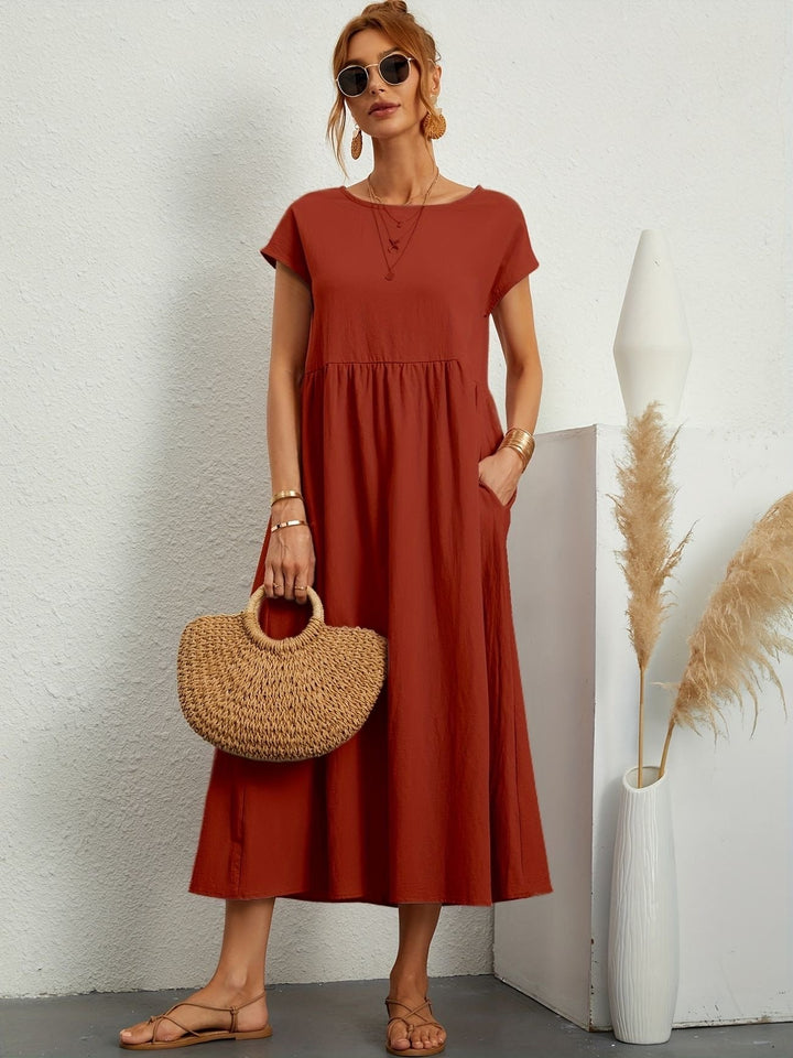 "Kimber - Midi-Relaxed Kleid mit Rundhalsausschnitt" could be rewritten as "Kimber - Midi-Relaxed Kleid mit Rundhalsdesign".