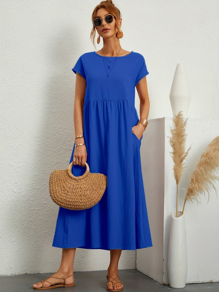 "Kimber - Midi-Relaxed Kleid mit Rundhalsausschnitt" could be rewritten as "Kimber - Midi-Relaxed Kleid mit Rundhalsdesign".