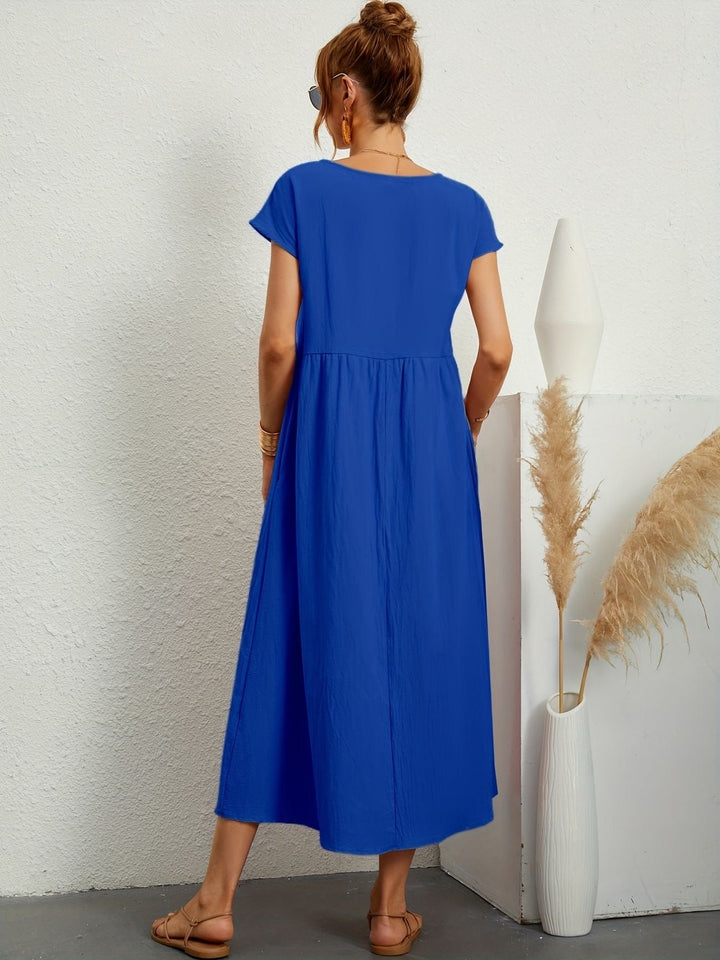 "Kimber - Midi-Relaxed Kleid mit Rundhalsausschnitt" could be rewritten as "Kimber - Midi-Relaxed Kleid mit Rundhalsdesign".