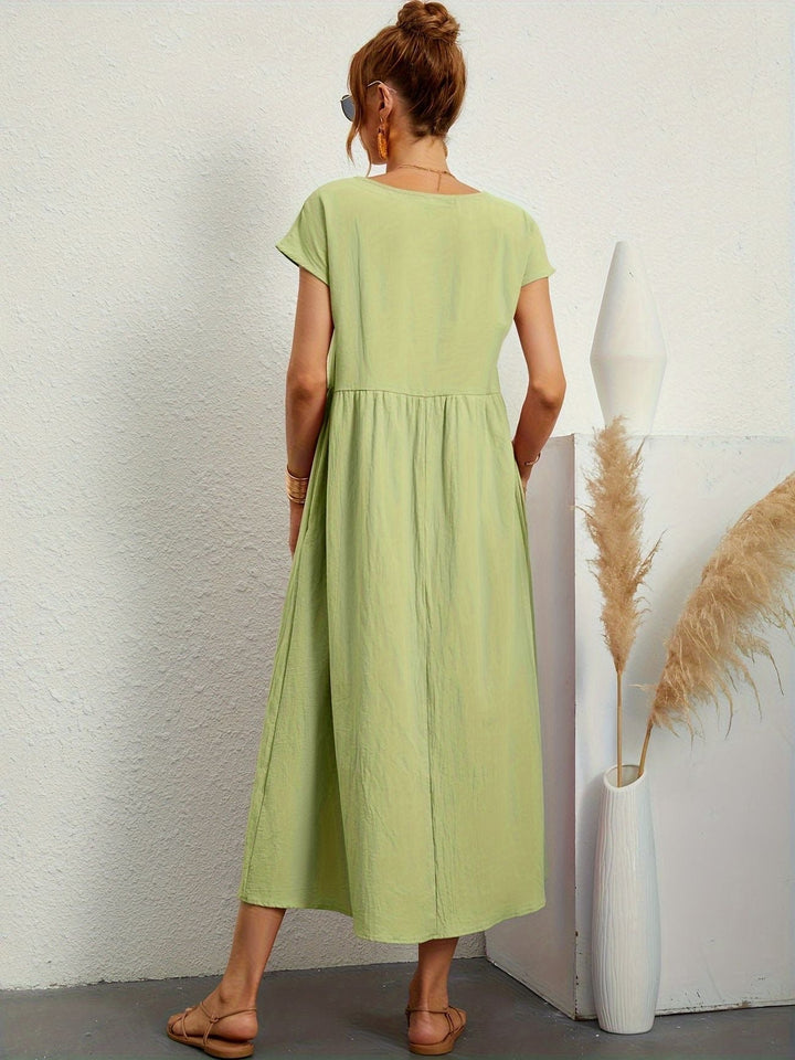 "Kimber - Midi-Relaxed Kleid mit Rundhalsausschnitt" could be rewritten as "Kimber - Midi-Relaxed Kleid mit Rundhalsdesign".